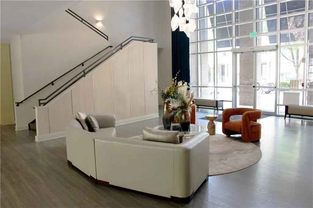 Common area featuring floor to ceiling windows and a high ceiling