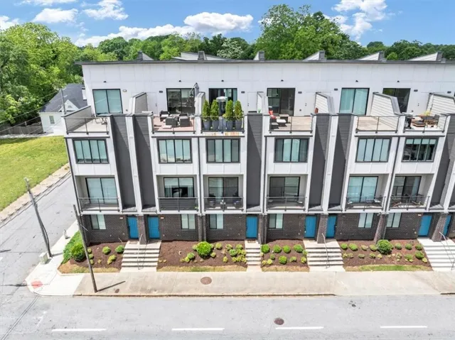 Modern townhome exterior featuring clean lines and a multi-level design