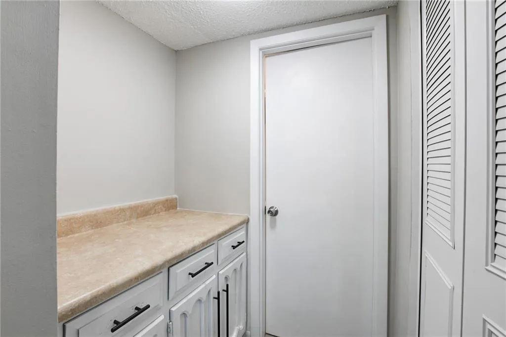 Bathroom with a textured ceiling and vanity