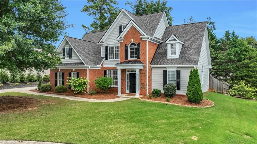 Traditional brick and concrete siding exterior with new roof July 2026