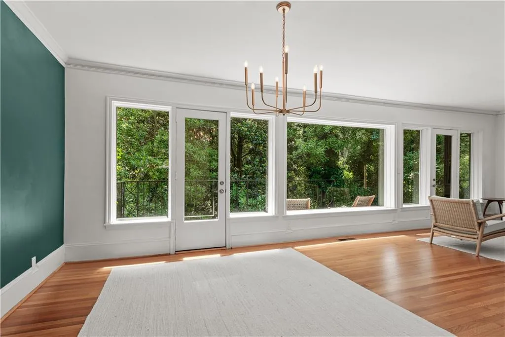 Wall of windows with tree house views.