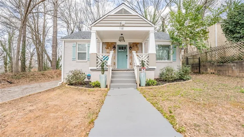 Craftsman-style facade featuring horizontal siding and brick veneer
