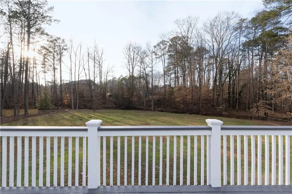 Wooden terrace featuring a lawn