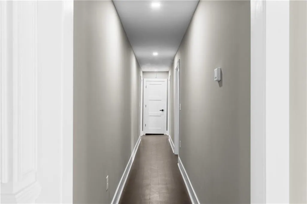 Hall featuring baseboards and recessed lighting