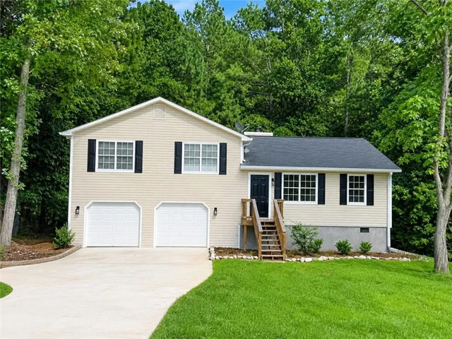 Exterior with light-colored siding, black shutters, and a dark roof