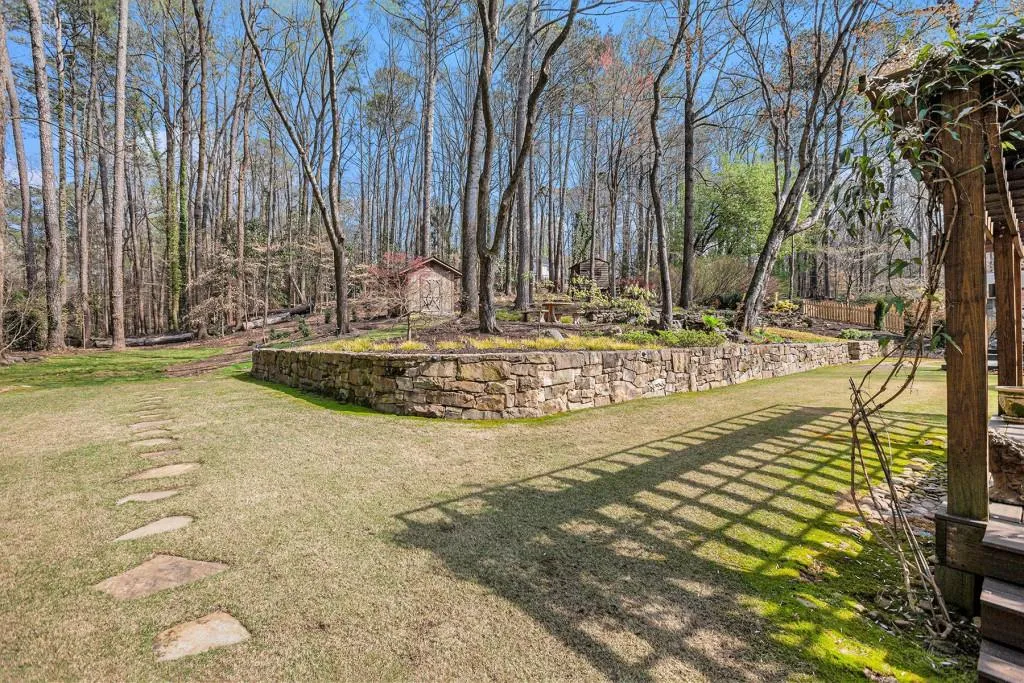 View of the gorgeous backyard and stone wall