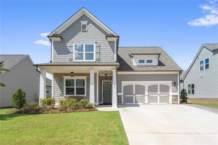 Two-story residence featuring a covered front porch with white columns