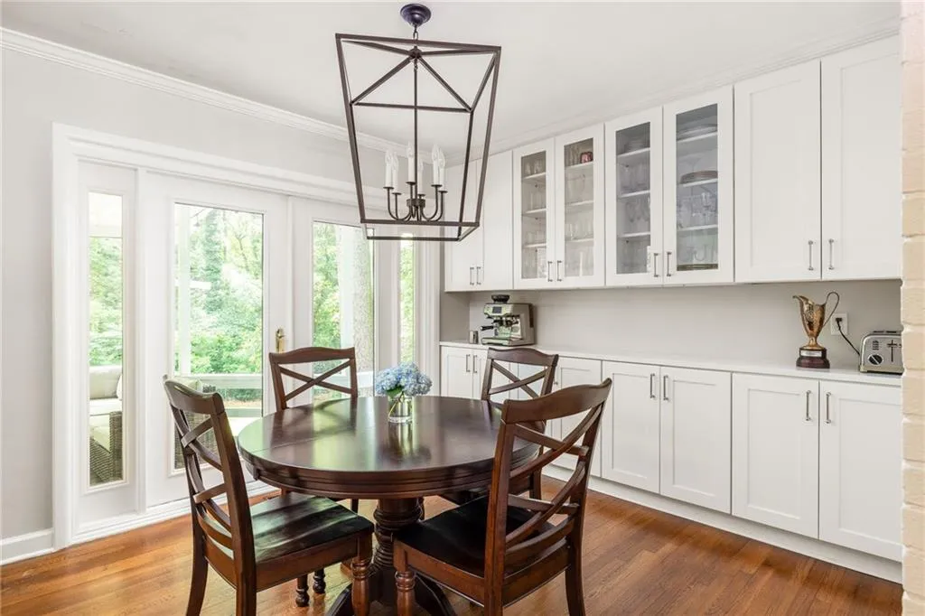 Dining room featuring an inviting chandelier, wood-type flooring, and ornamental molding