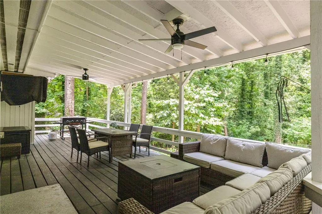 Wooden terrace featuring an outdoor living space and ceiling fan