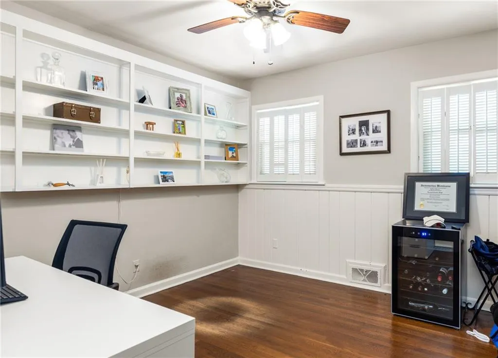 Office space featuring beverage cooler, dark hardwood / wood-style flooring, and ceiling fan