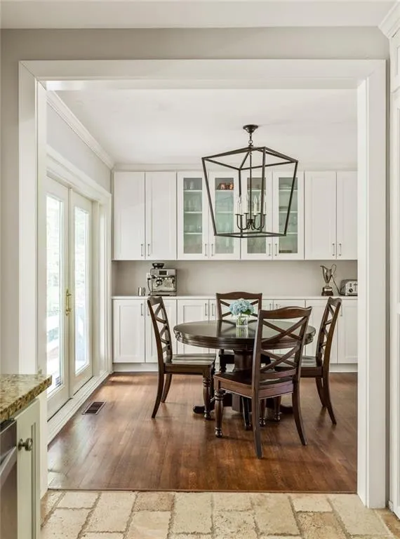 Dining room featuring crown molding, light hardwood / wood-style flooring, and a wealth of natural light