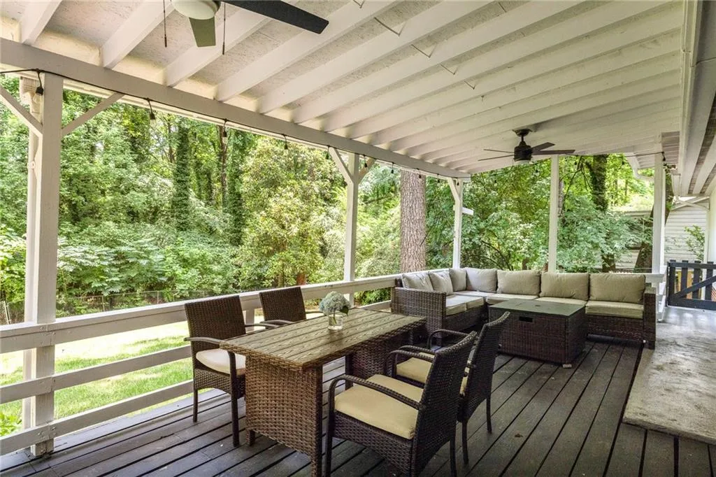 Wooden terrace featuring outdoor lounge area and ceiling fan