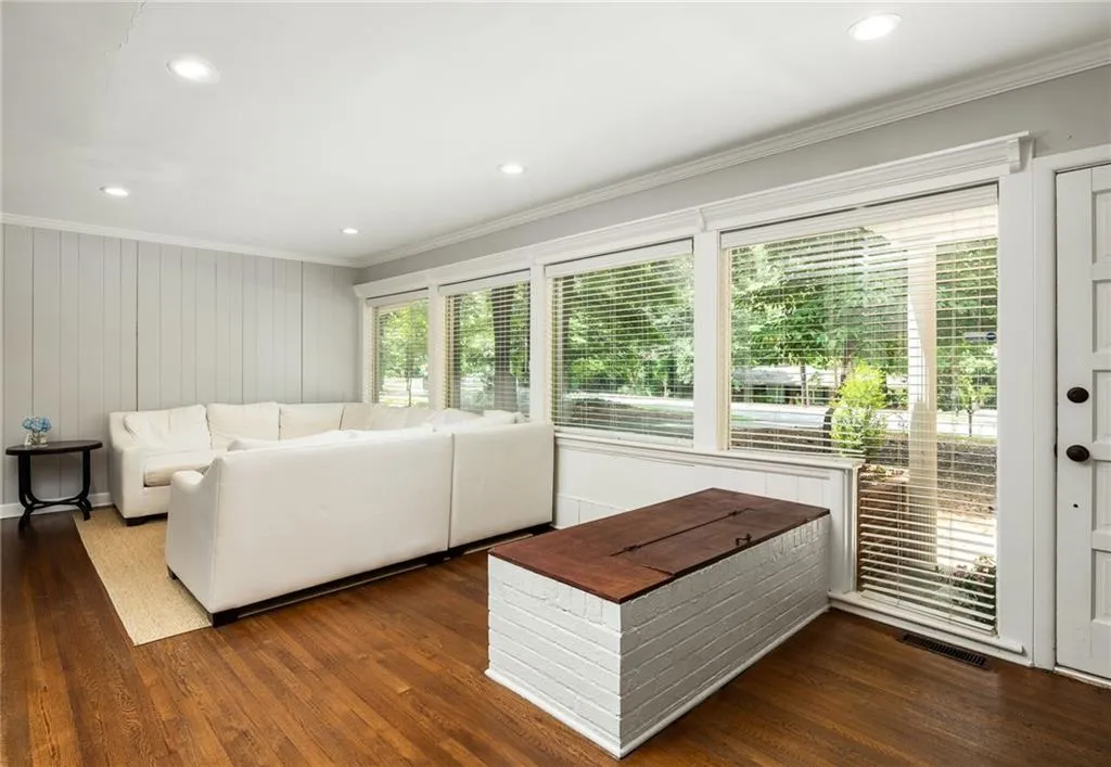 Living room featuring ornamental molding and dark hardwood / wood-style floors