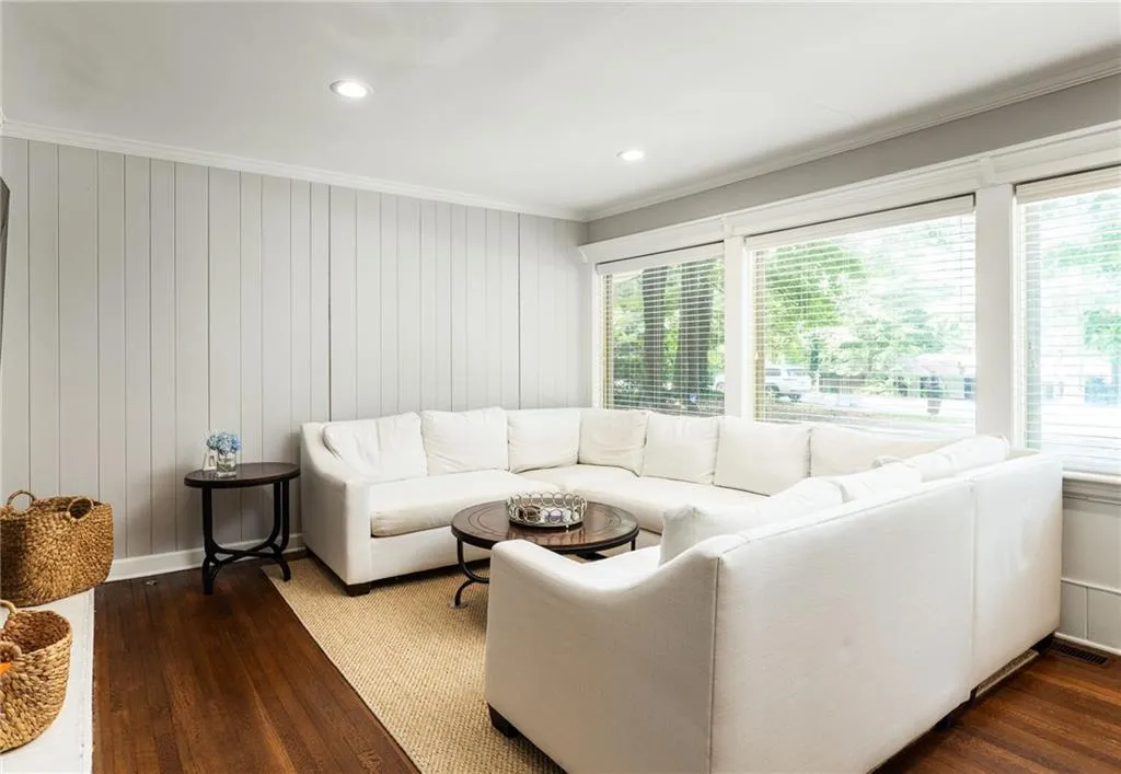 Living room featuring dark hardwood / wood-style flooring and ornamental molding