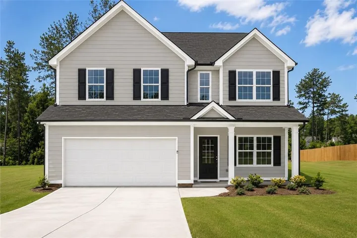 Two-story residence featuring light gray siding, a dark shingle roof, and a two-car garage