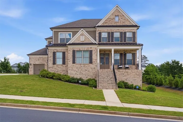 Two-story traditional residence featuring a brick and siding exterior