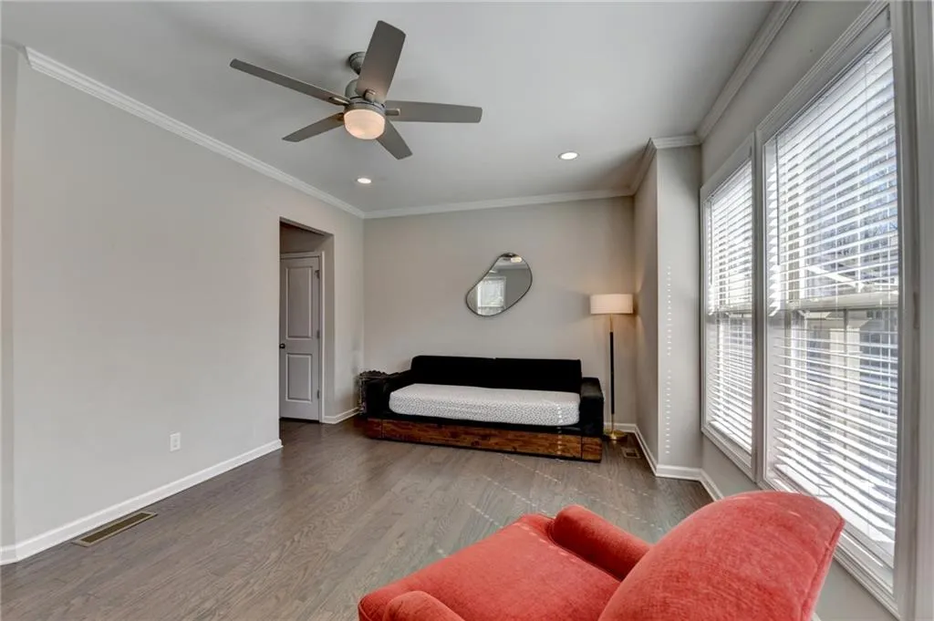 Bedroom featuring recessed lighting, wood finished floors, visible vents, baseboards, and crown molding