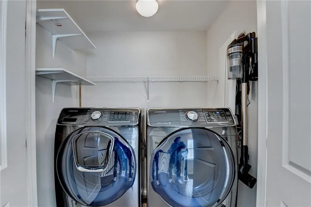 Washroom featuring washing machine and dryer and laundry area