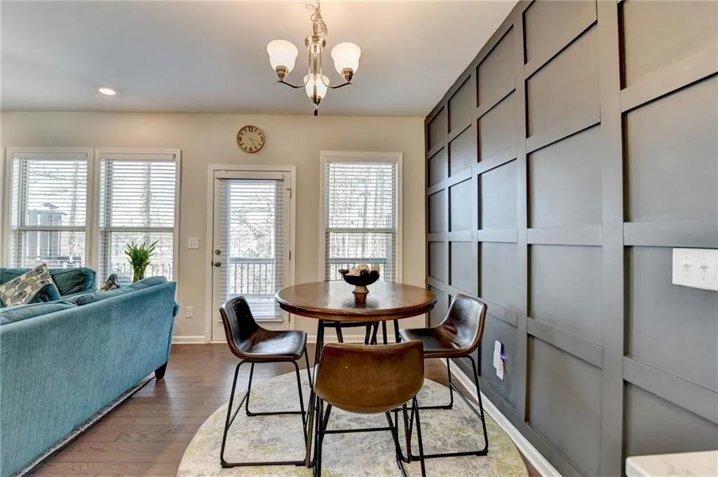 Dining space with recessed lighting, dark wood finished floors, baseboards, and an inviting chandelier