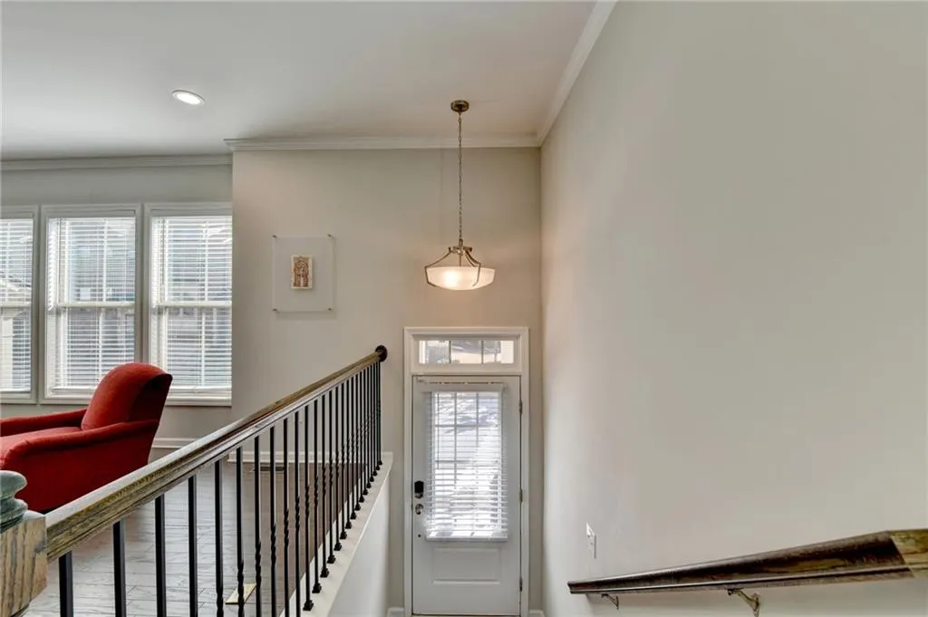Foyer entrance featuring ornamental molding, wood finished floors, and recessed lighting
