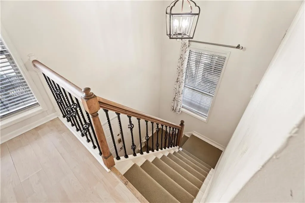 Stairway with wood finished floors and a chandelier Stairway with wood finished floors and a chandelier