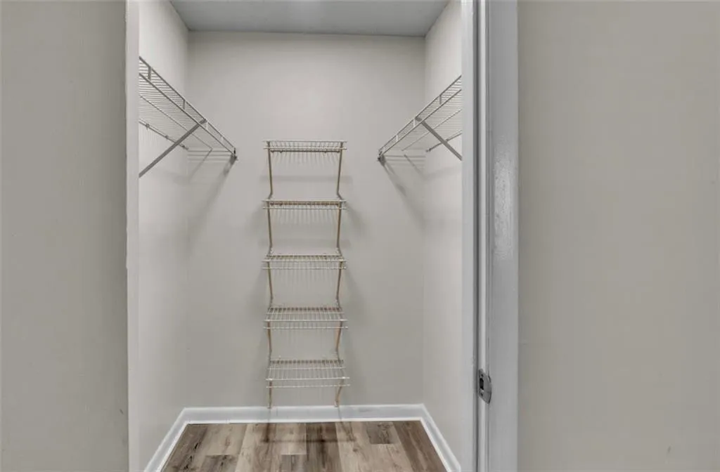 Walk in closet featuring light wood-style floors