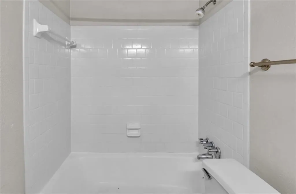 Bathroom with shower / bath combination and toilet