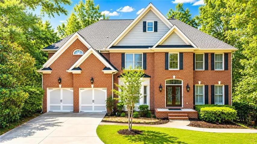 Traditional brick exterior with white trim, featuring a symmetrical facade