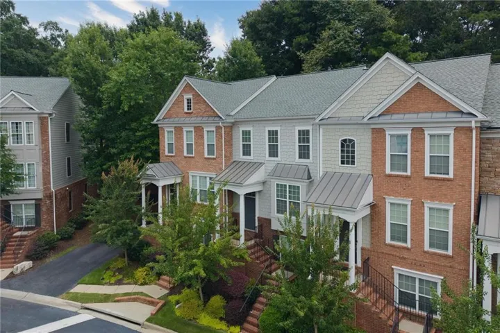 Brick and siding exteriors with gabled roofs, multiple windows, and covered entryways
