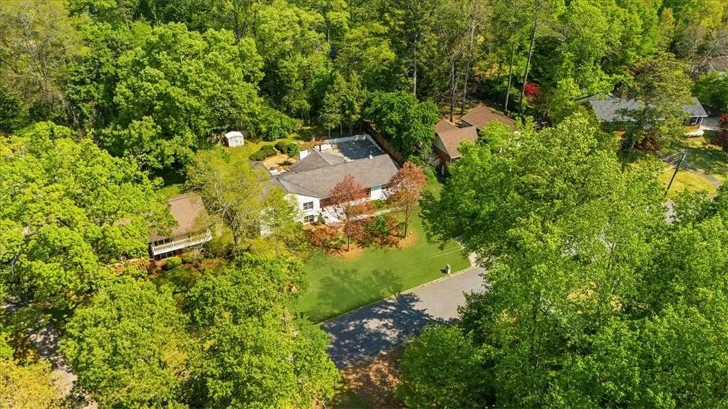 Aerial view featuring a forest view