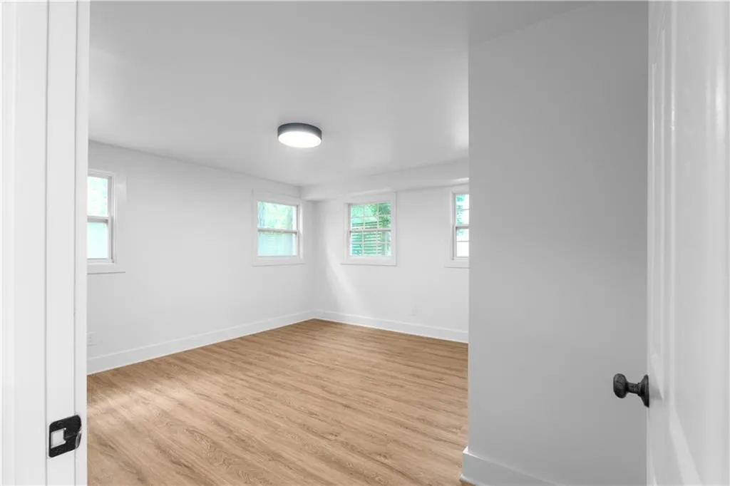 Spare room with wood finished floors and baseboards