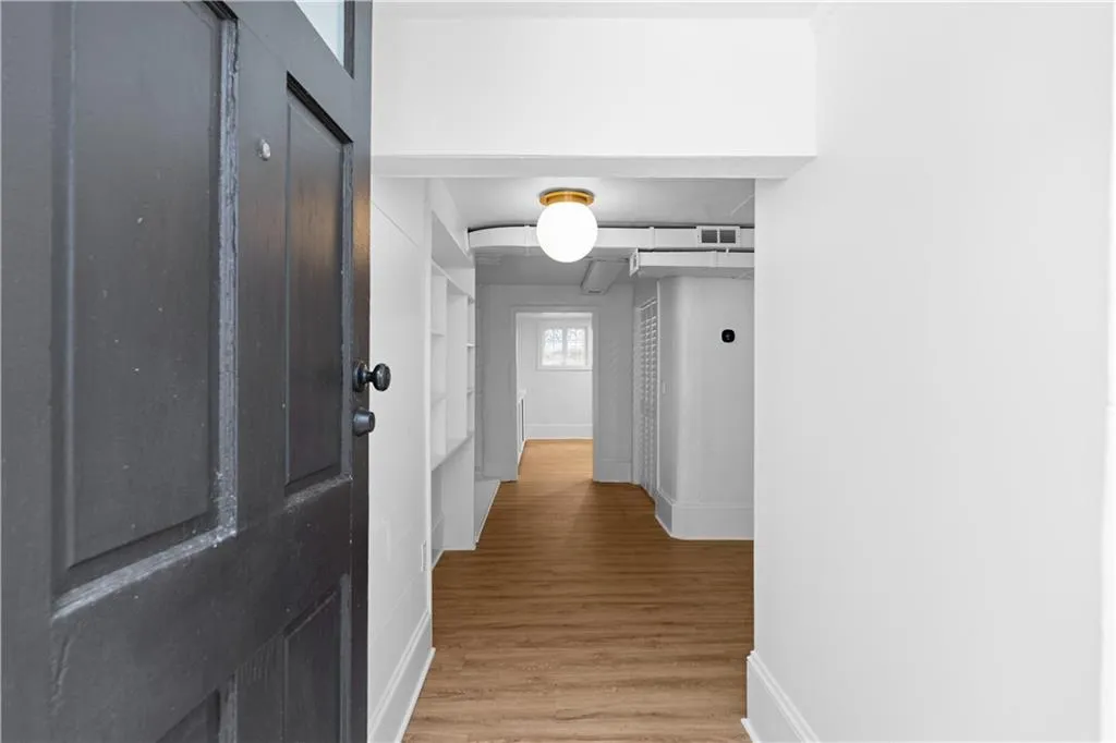 Hall featuring baseboards and light wood-style floors