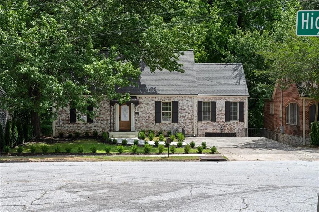 Cape cod house with brick siding and roof with shingles