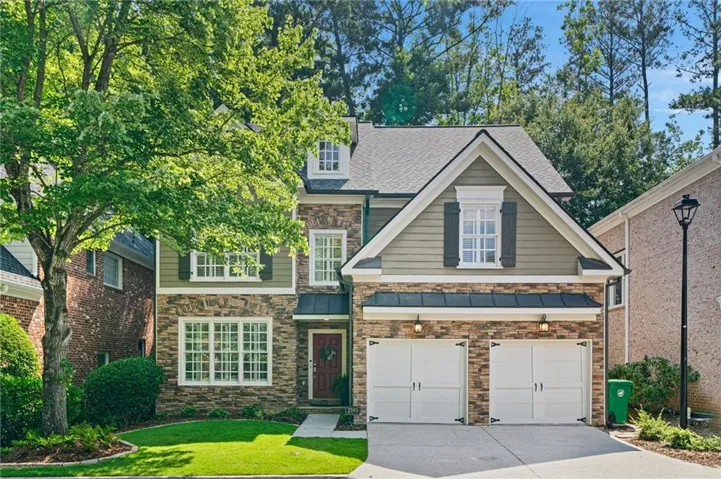 Two-story residence featuring a stone and siding facade