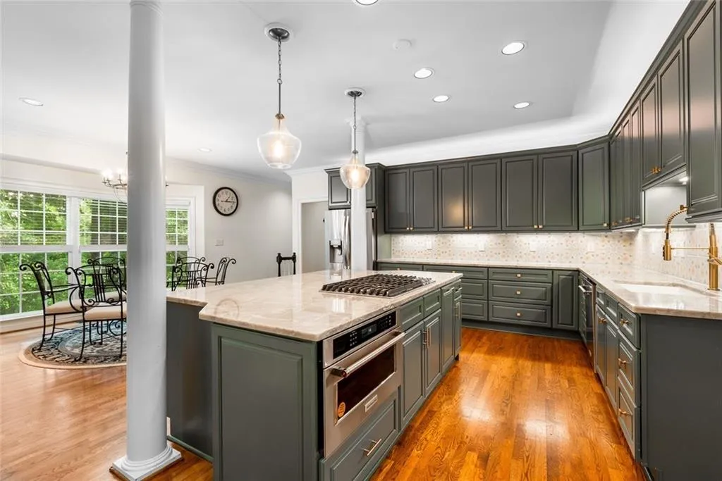 The Chef Kitchen features all new custom cabinetry, Vancouver quartzite countertops, oversized island, premium KitchenAid appliances, and a built-in coffee station