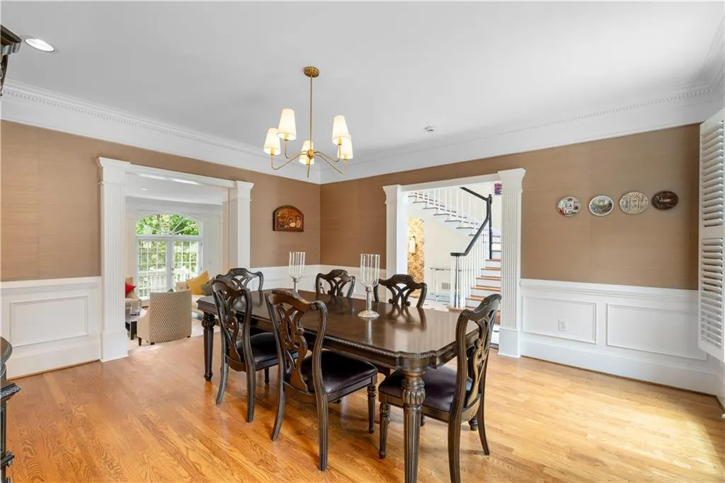 Large Dining Room with plantation shutters, chair rail molding