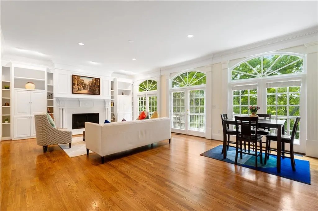 Spacious fireside Family room with a wall of window