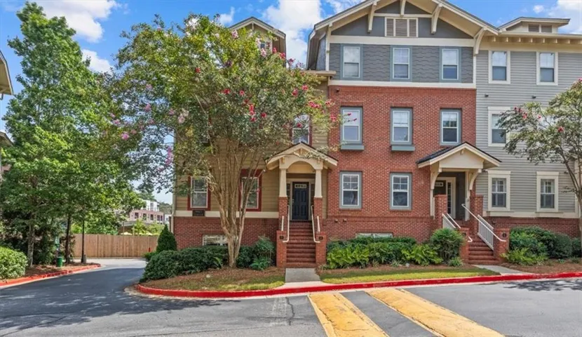 Traditional-style multi-story building featuring a brick facade and shingle siding