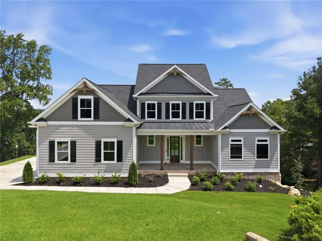 Contemporary craftsman exterior with gabled roof lines, board and batten siding, stone accents, and a covered entry