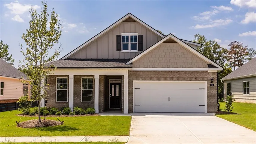 Brick and siding exterior with a covered entry, column accents, and a two-car garage