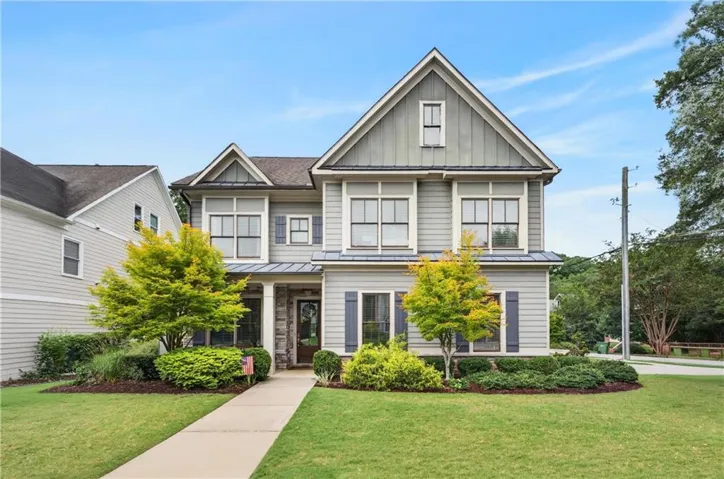 Two-story residence featuring light gray siding and dark gray trim accents
