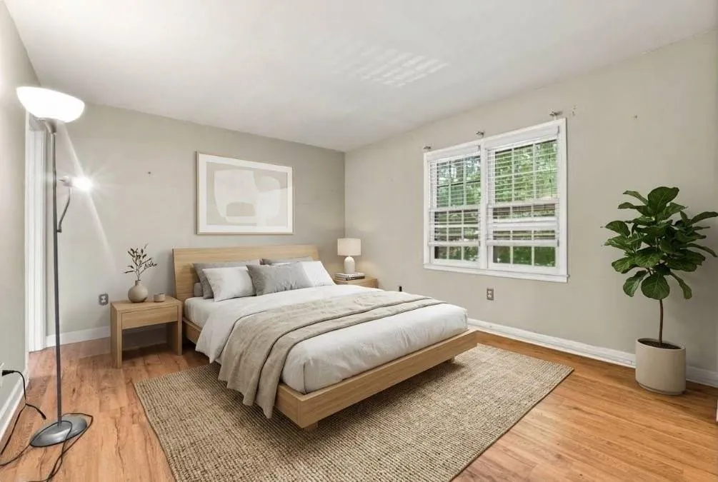 Hardwood flooring, light gray wall paint, and white trimVirtually staged photo