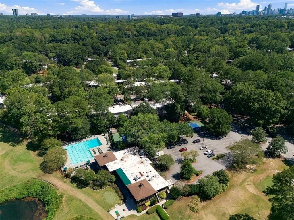 Expansive grounds featuring a swimming pool, tennis court, and an adjacent golf course
