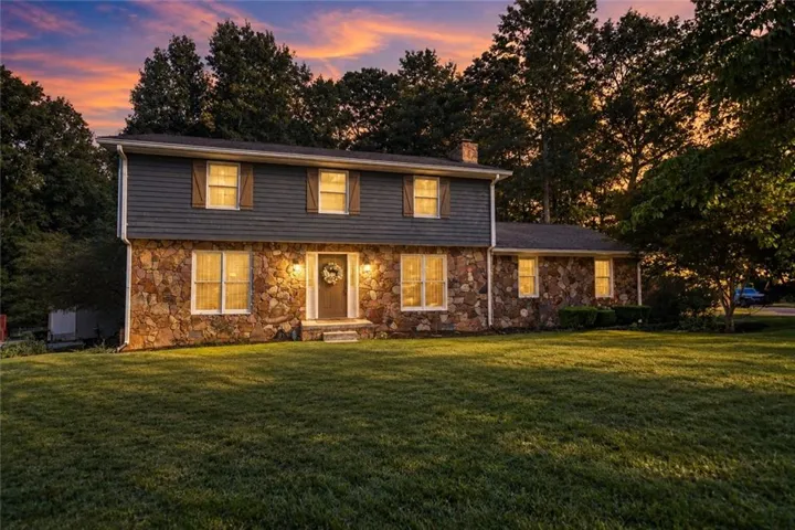 Stone and siding exterior with a prominent front entrance