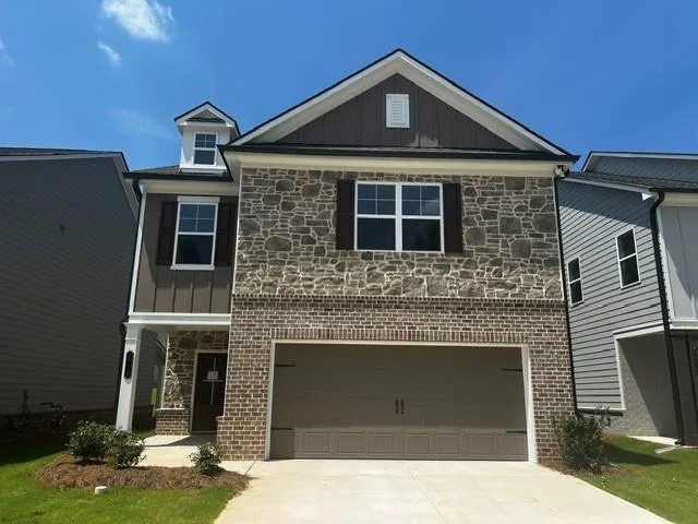 Two-story exterior featuring a stone and brick facade