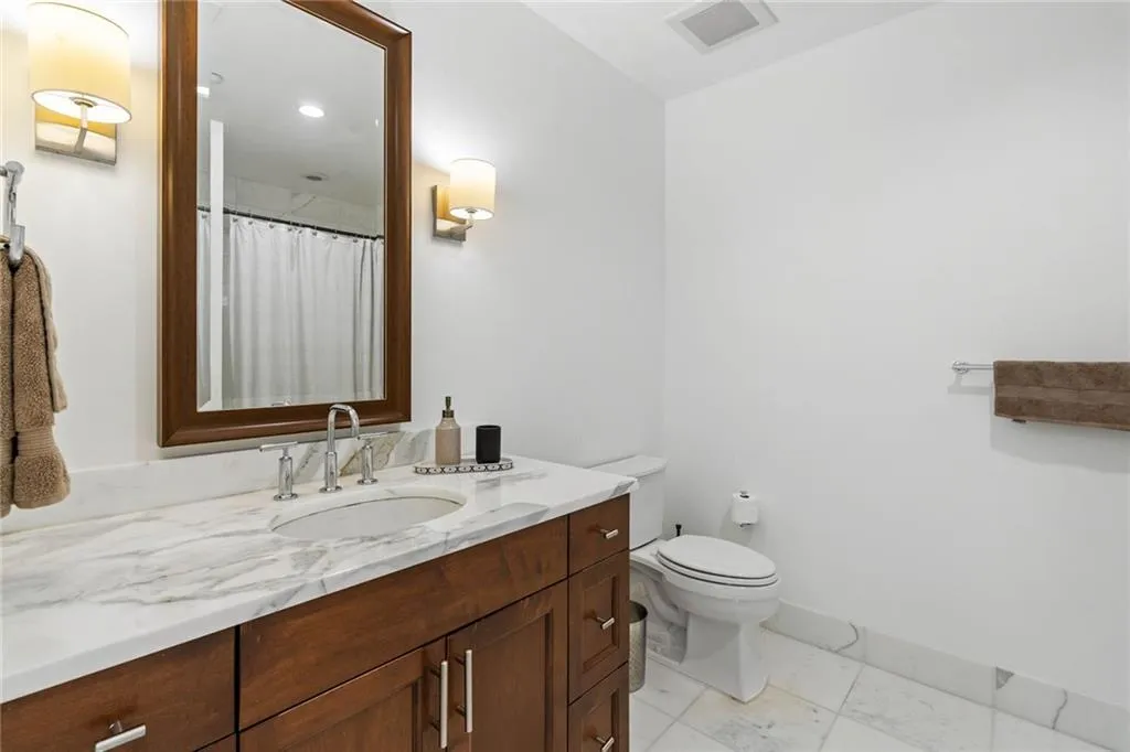 Bathroom featuring vanity and curtained shower