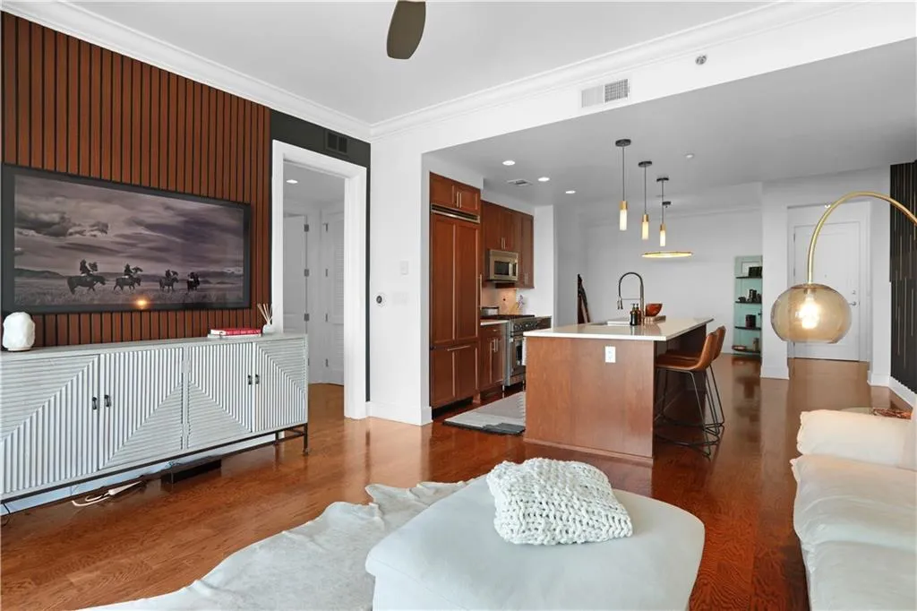 Living area with dark wood-style flooring, crown molding, recessed lighting, and a ceiling fan