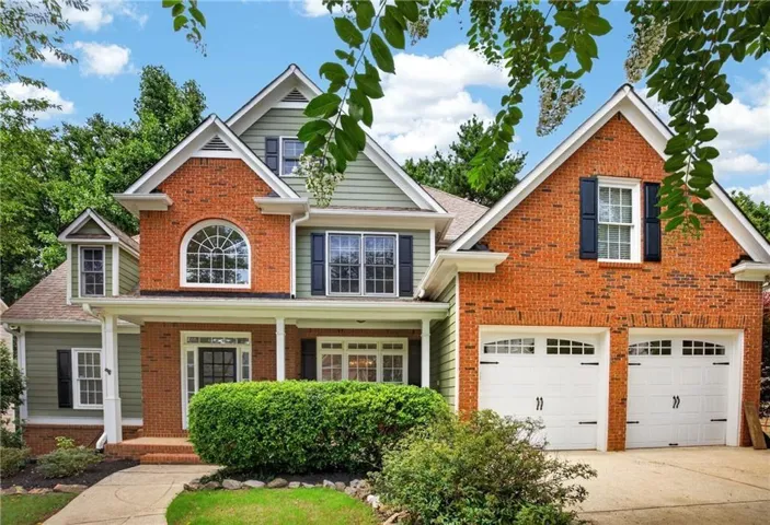 Traditional-style residence featuring brick and siding construction