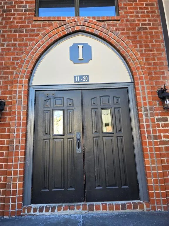 Doorway to property with brick siding