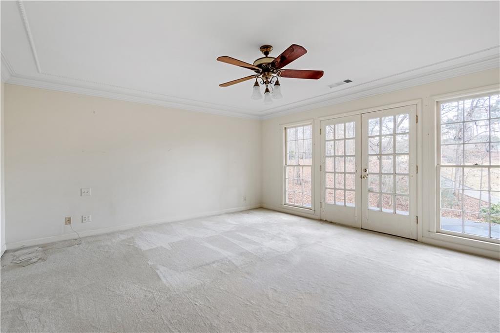 Master bedroom featuring ornamental molding, a wealth of natural light, french doors and ceiling fan